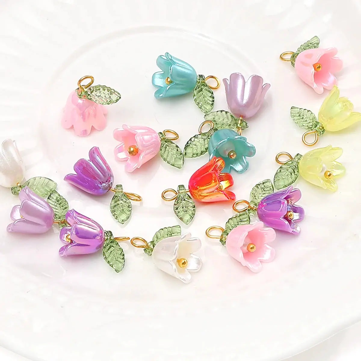 Assorted lily of the valley acrylic flower beads with green leaves and gold loops, 11x14mm