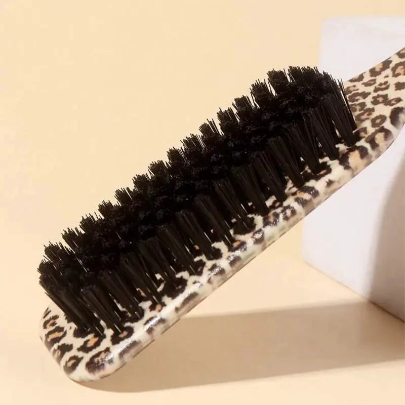 Slick-back hair brush with leopard-print handle and dense black bristles