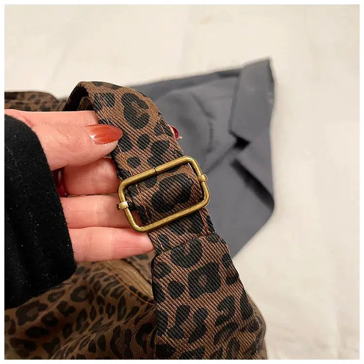 Trendy leopard print soft textile shoulder bag for women, adjustable strap with brass buckle, large capacity.