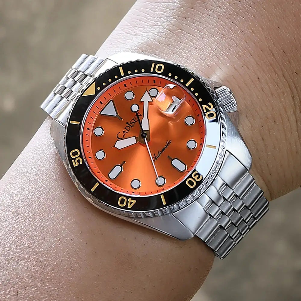 CADISEN men's automatic wristwatch with orange dial, ceramic bezel, sapphire glass, and stainless steel bracelet.