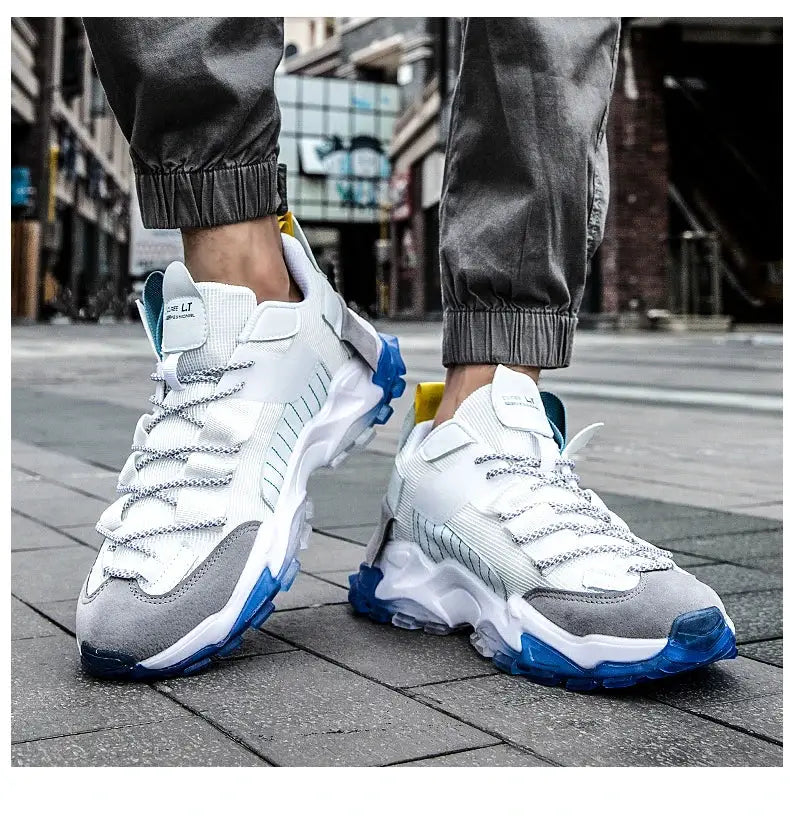 Pair of Simples Market white men's sneakers with blue outsole, gray toe cap and chunky sole