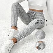 Women's grey ribbed stretch leggings with elastic waistband for casual sporty wear.