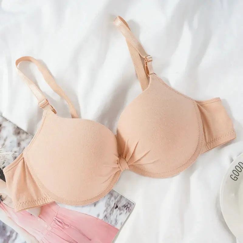 Women's nude underwire push-up bra with molded cups and adjustable straps.