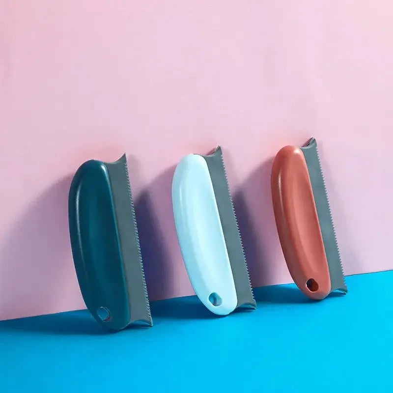 Lint remover brush set for fabric and upholstery; three handheld fuzz removers in teal, light blue, and brown.
