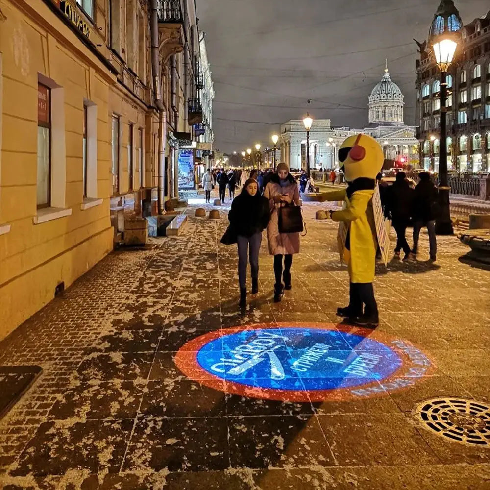 Advertising Gobo Projector by Simples Market outdoor LED rotating logo projector projecting blue logo on pavement