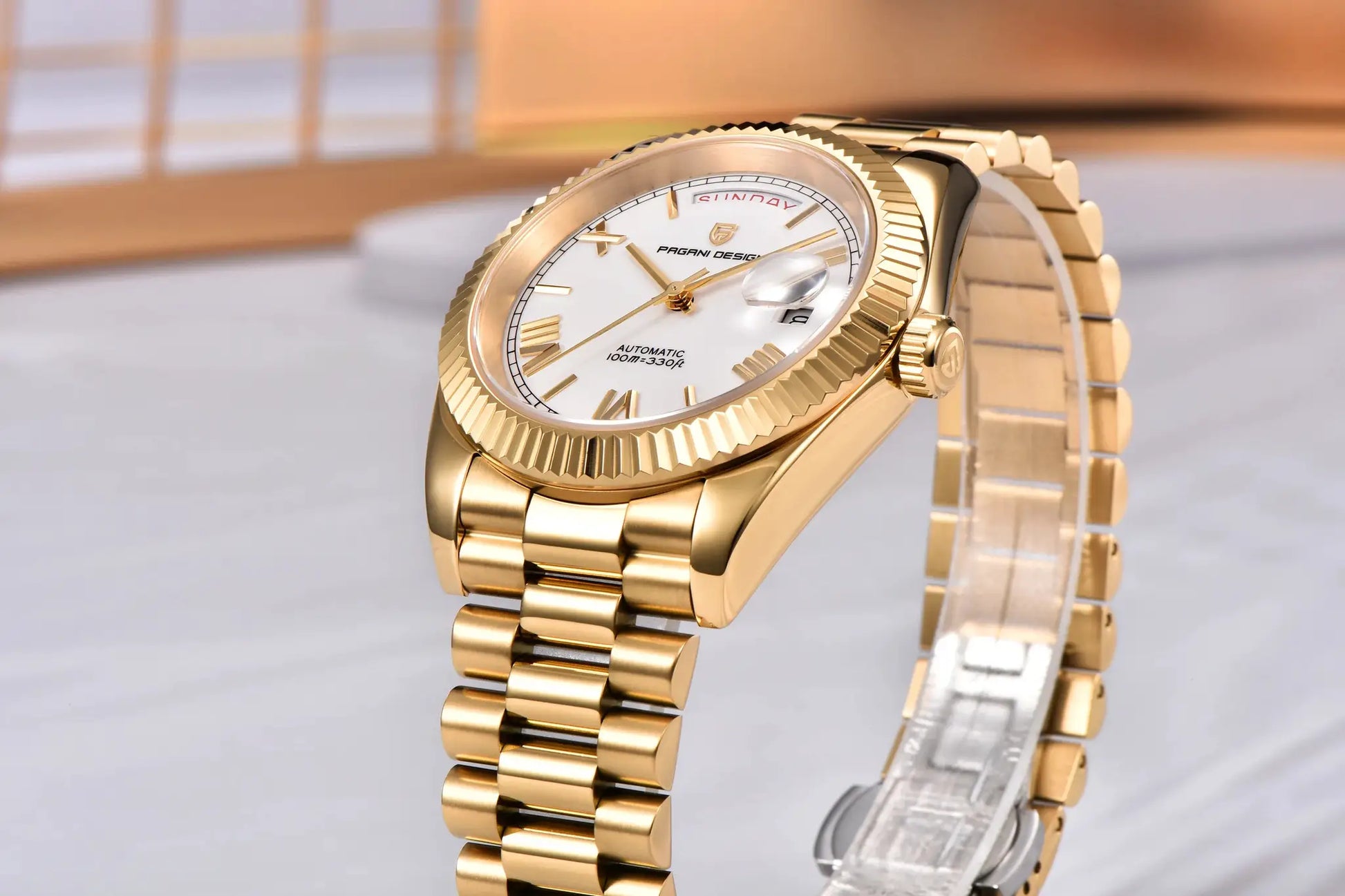 Pagani Design men's gold watch with white dial, automatic movement, date window, fluted bezel.