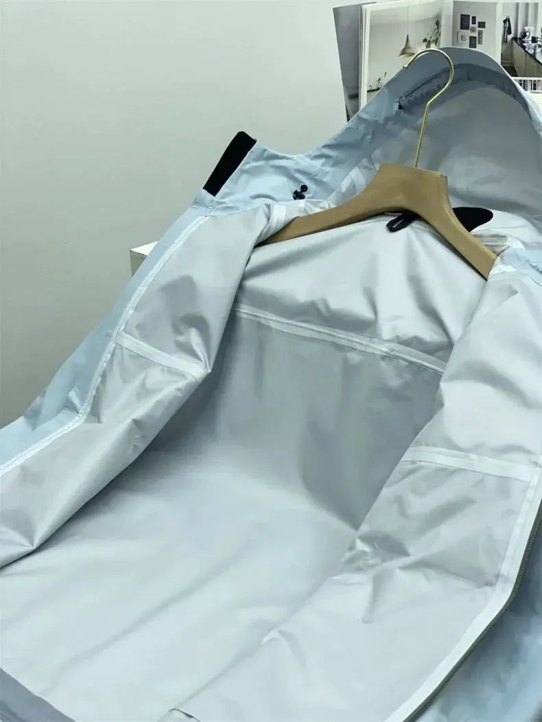 Men's light-blue windproof soft-shell outdoor jacket by Simples Market, opened on a hanger.