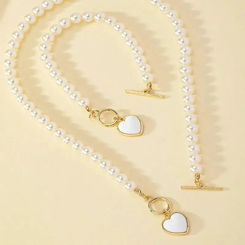 2-piece imitation pearl necklace and bracelet set with white beads and gold-tone heart pendant charms