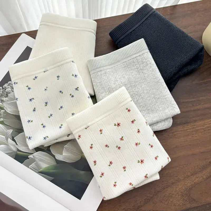 5-pack women's mid-waist panties in soft knit fabric; assorted solid colors and floral prints