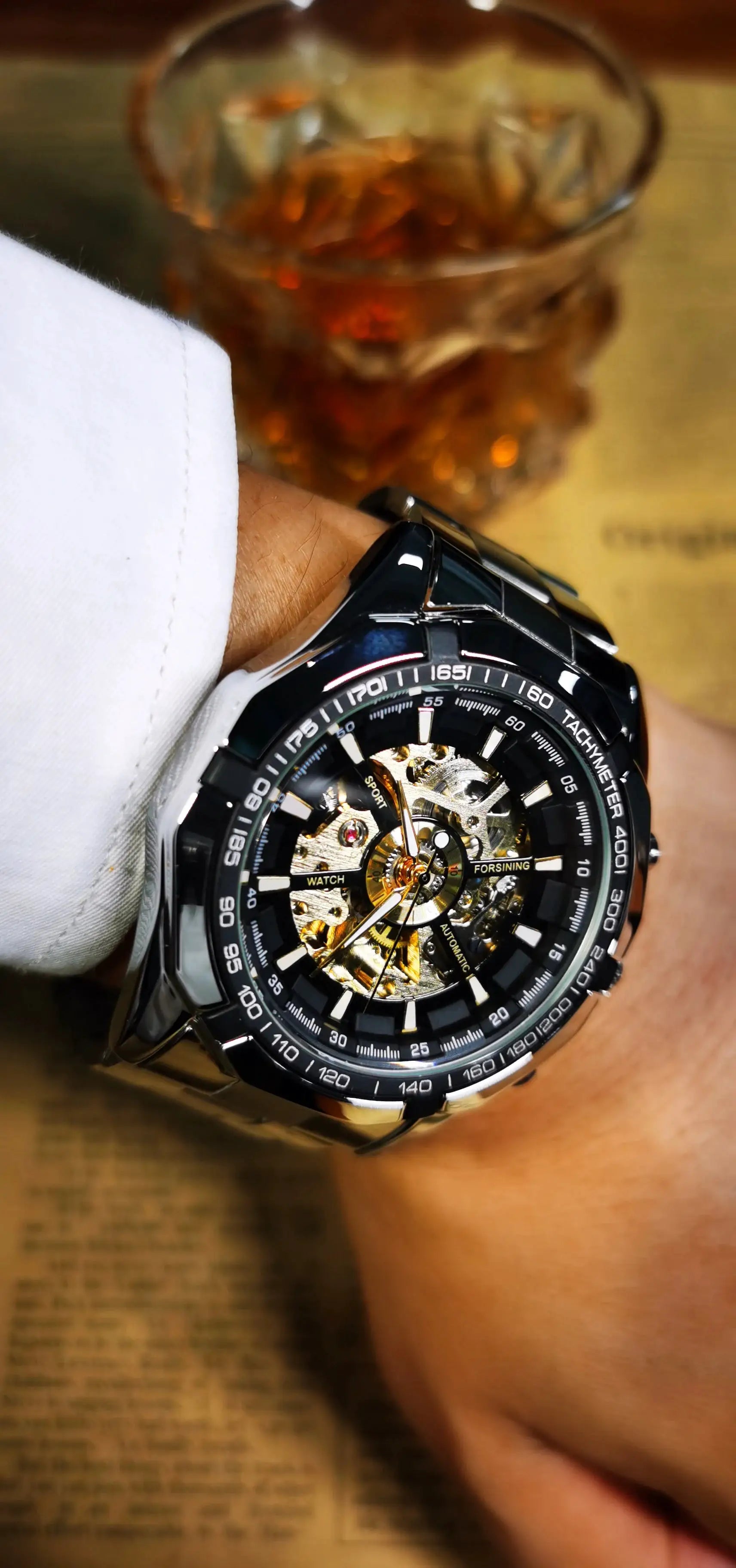 Forsining skeleton wristwatch with stainless steel strap, visible gold gears, luminous hands