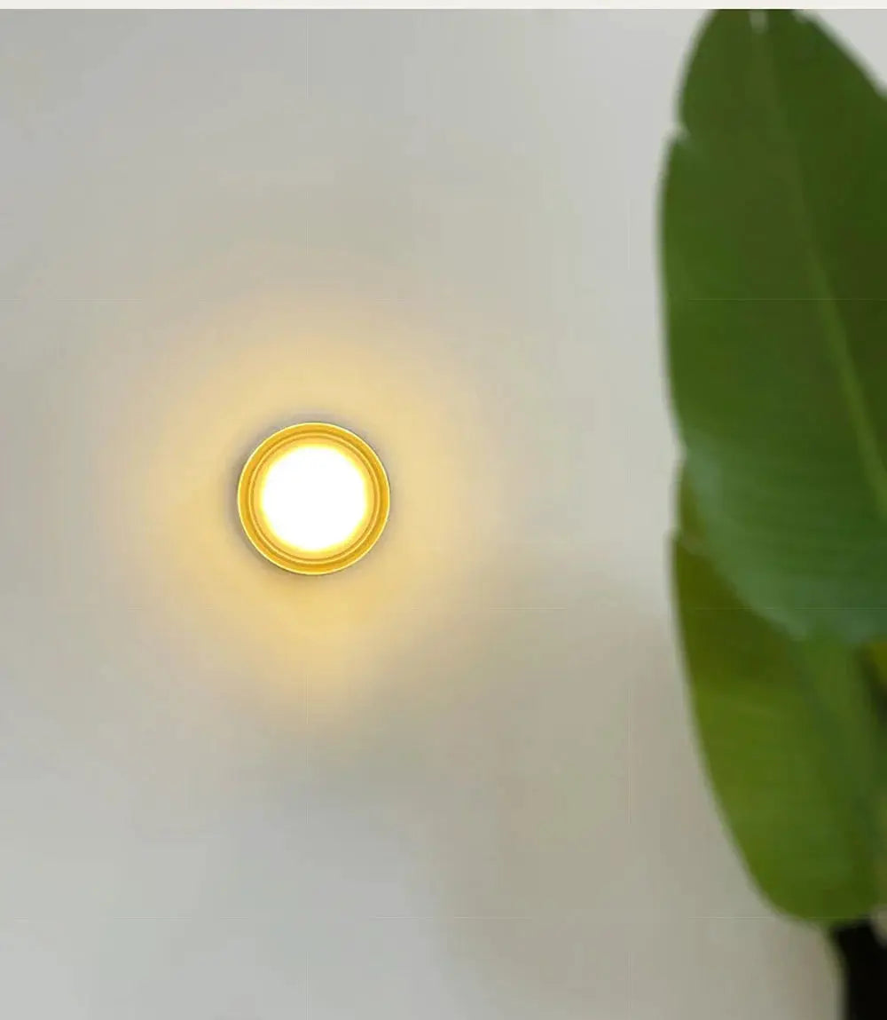 Simples Market round amber glow LED wall sconce in smoky grey finish for living room decor