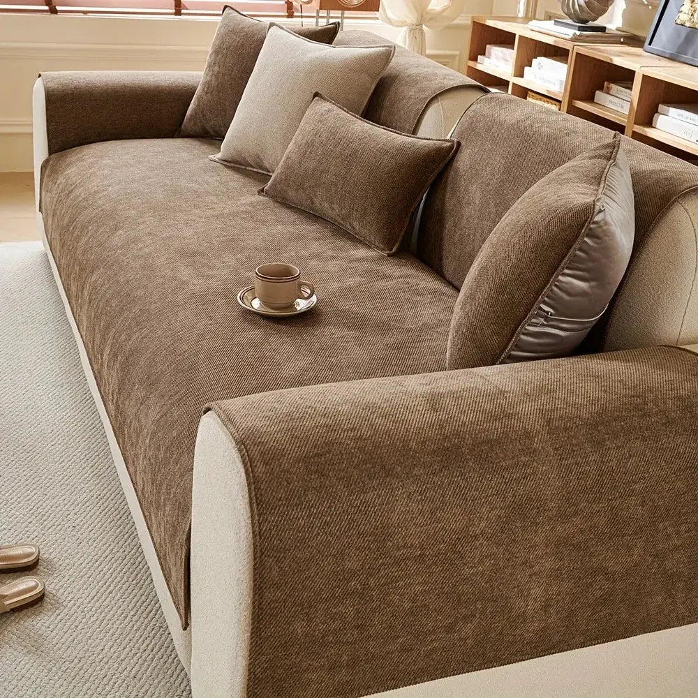 Minimalist twill chenille anti-slip sofa cover in warm brown on a living room couch with matching pillows