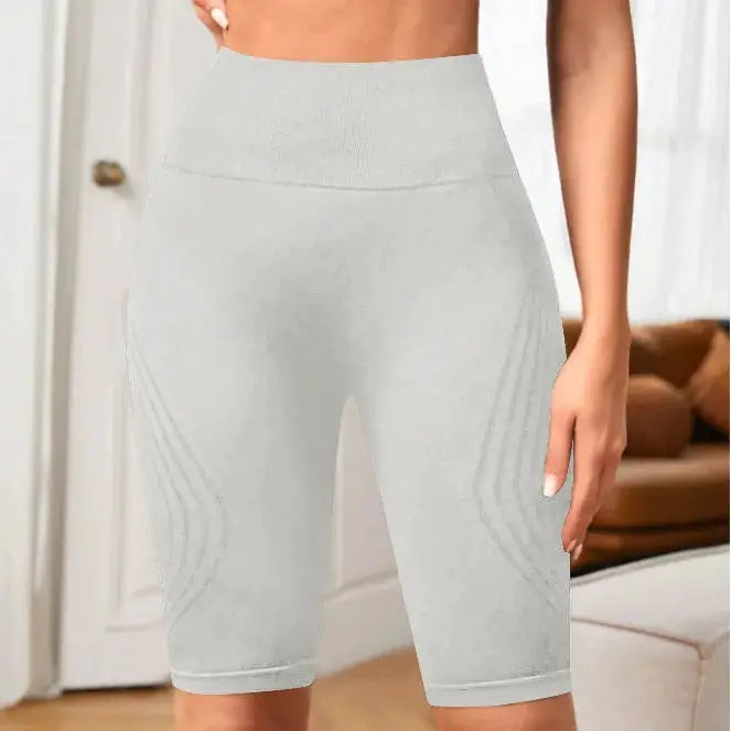 High-waisted seamless yoga shorts for women in light gray knitted stretch fabric with hip-lift design.