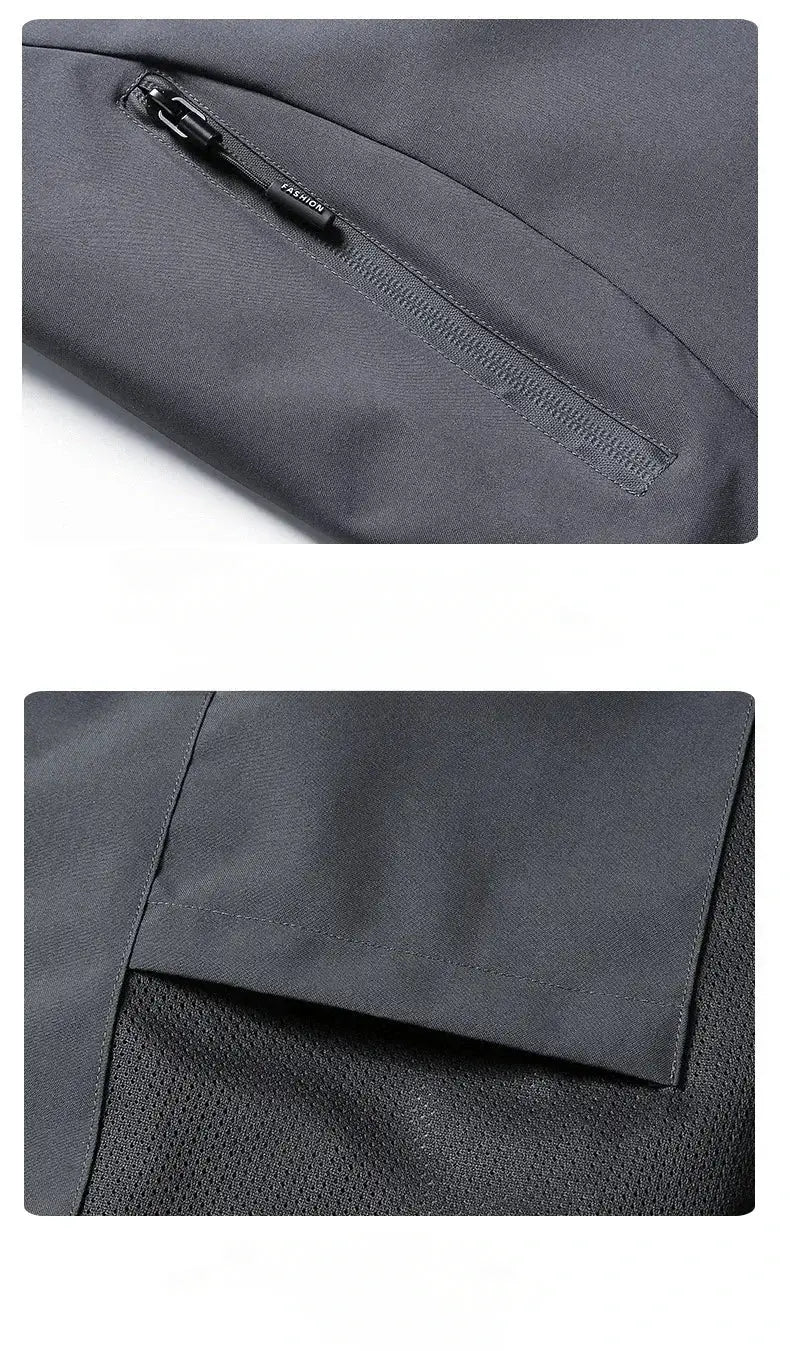 Men's gray waterproof hooded rain jacket with zip pocket detail.