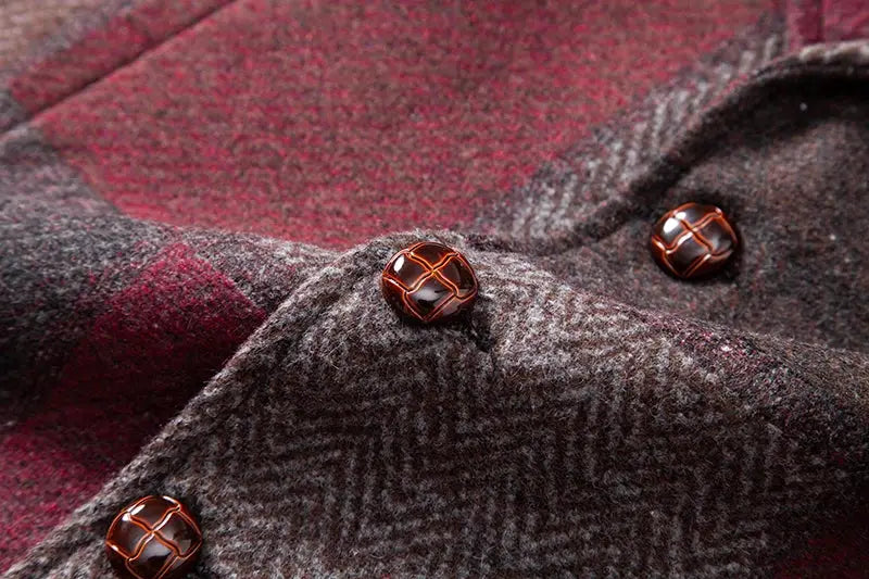 Men's tweed plaid vest fabric with brown buttons; close-up herringbone texture.