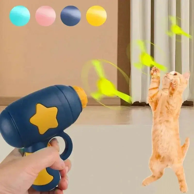 Blue interactive cat training launcher with yellow star, shooting colorful discs as orange kitten leaps to catch them