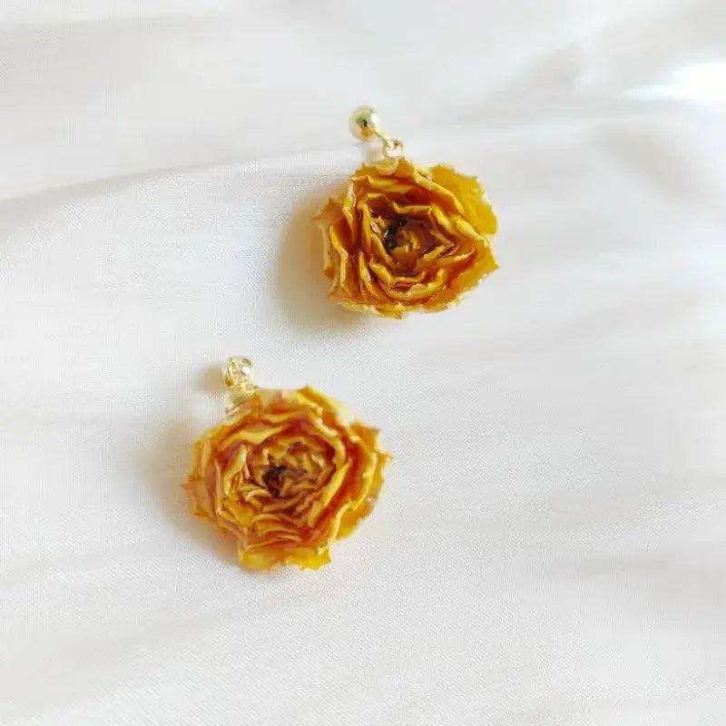 Immortal rose long earrings in epoxy resin with yellow rose petals on gold-tone findings, pair shown.