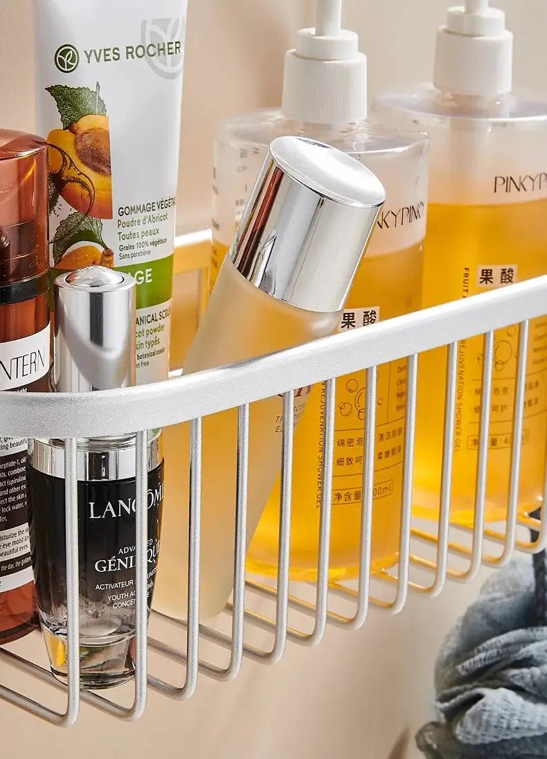 Shower caddy hanging organizer with hooks, white metal wire rack holding Yves Rocher, Lancôme and Pinky bottles.