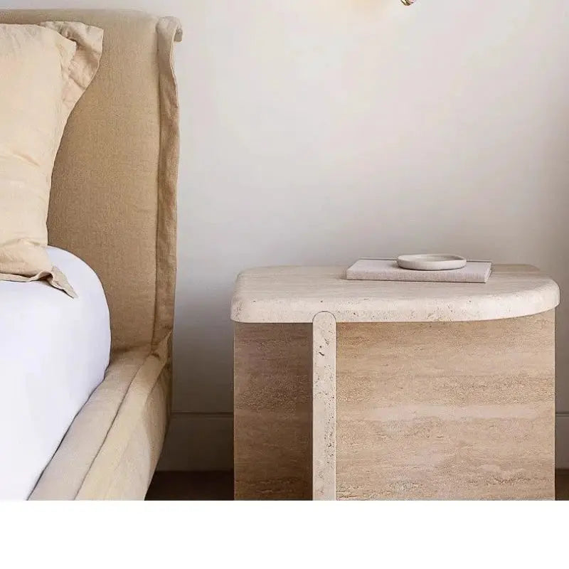 Natural stone wall lamp sconce in a neutral bedroom setting with beige headboard and wooden nightstand