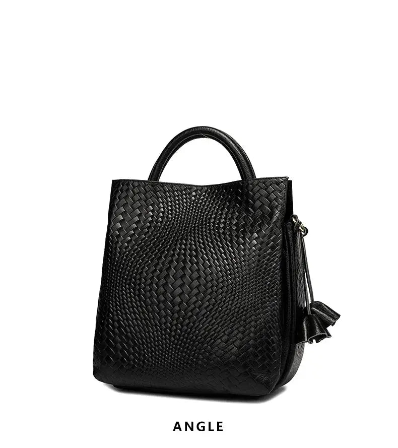 Women's black cowhide woven handbag with top handle and side tassel by Simples Market