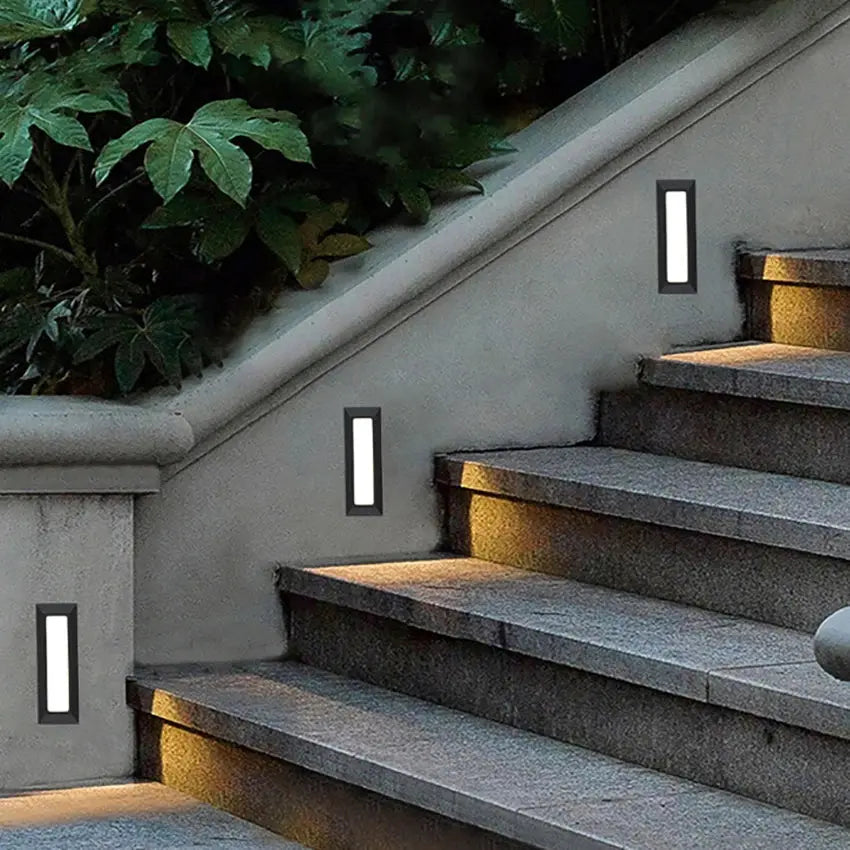 Surface-mounted LED stair light, 6W, waterproof black alloy frame; four outdoor wall lamps along concrete staircase.