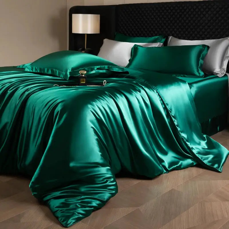 Silk bed sheets set in emerald green satin with duvet cover, fitted and flat sheets, and pillowcases