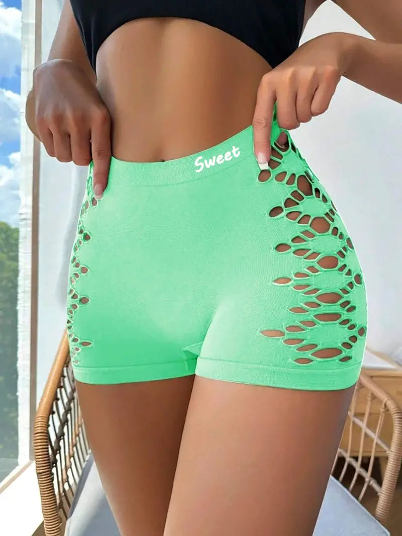 Seamless sports shorts in neon green with side mesh hollow-out panels; waistband reads Sweet