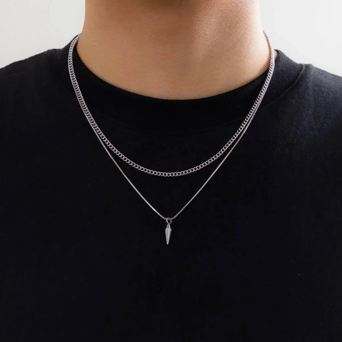 2pc stainless steel necklace set in silver: Cuban link choker and thin snake chain with a cone pendant.