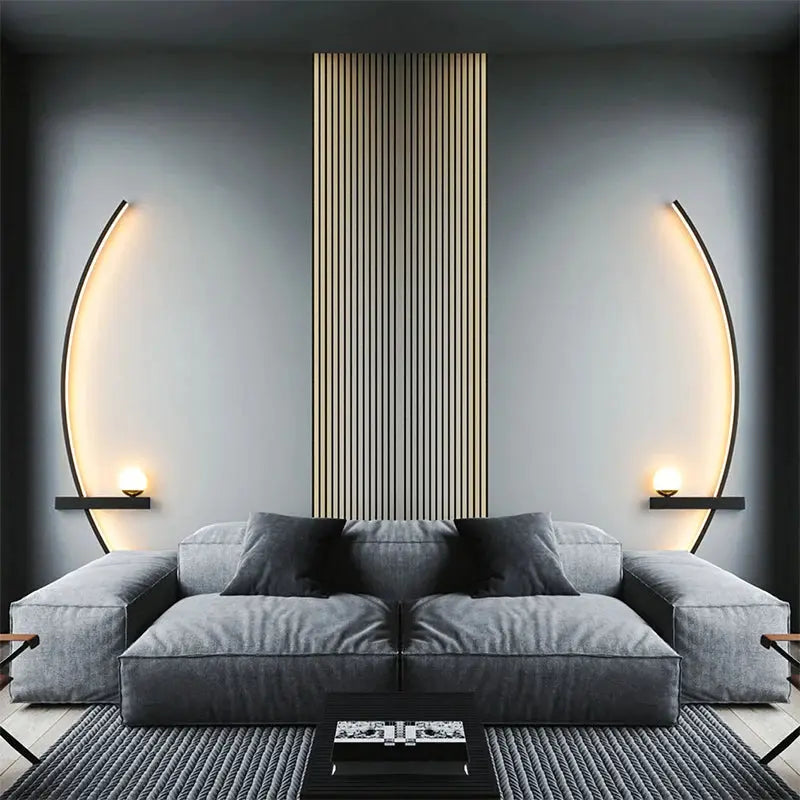 LED wall lamp pair in black with curved arches and warm lighting beside a gray sofa