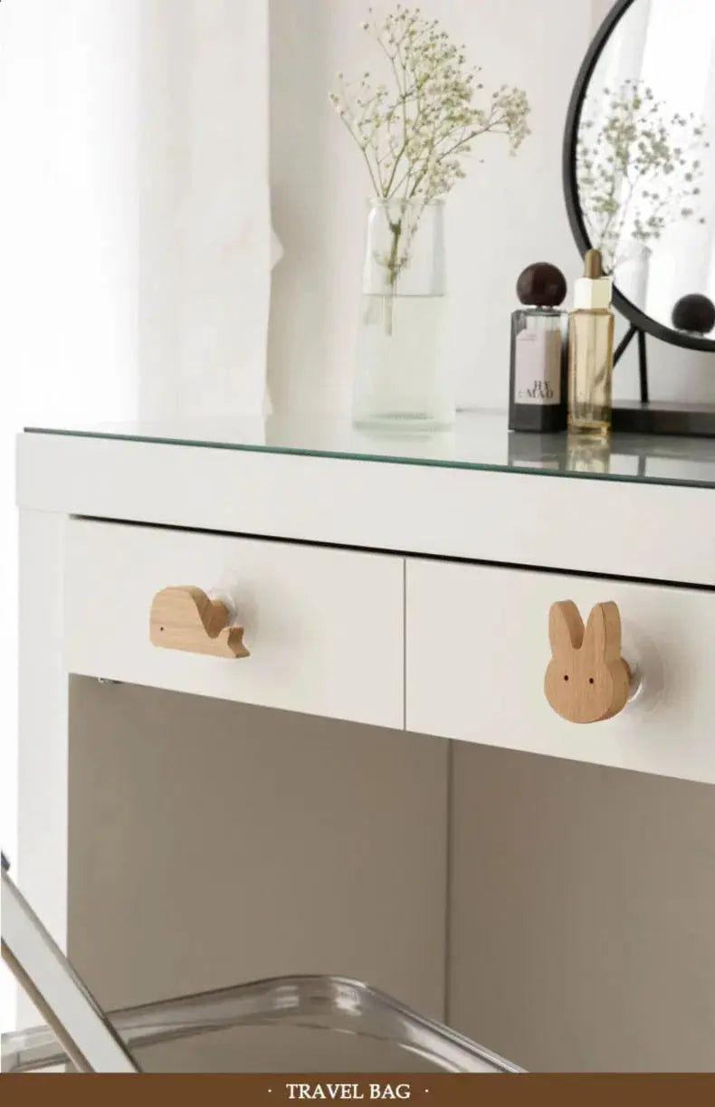 Two natural wood animal hooks for kids' room; solid wood coat and key hooks on a white dresser