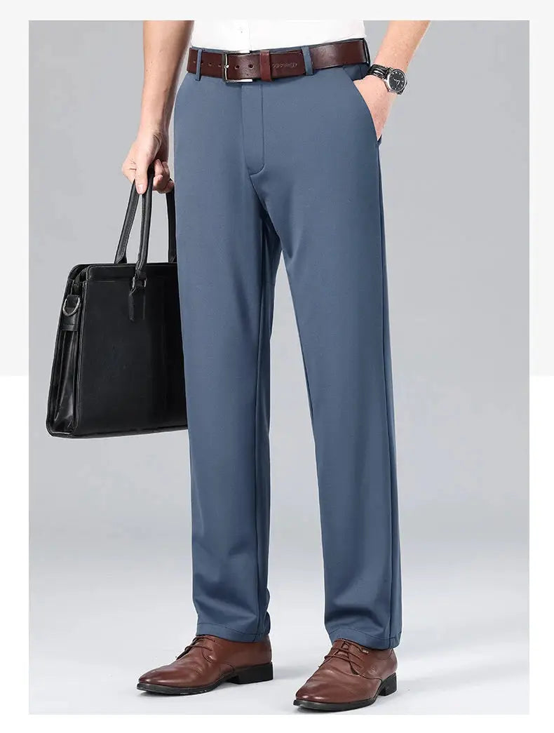 Mens stretch dress pants, blue-gray by Simples Market; paired with brown belt and brown oxfords, carrying a black bag.