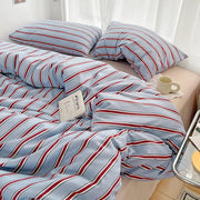 Duvet cover and four-piece striped sheet set in red and blue on washed cotton bedding