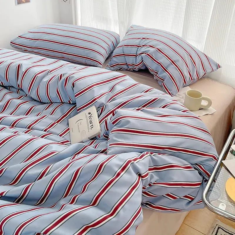 Duvet cover and four-piece striped sheet set in red and blue on washed cotton bedding