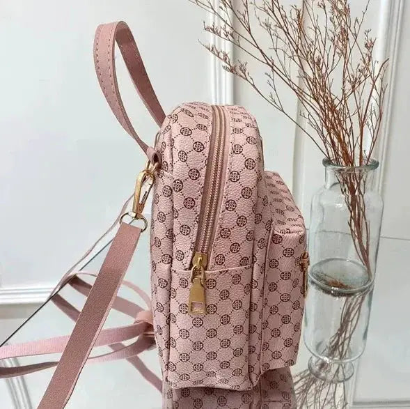 Backpack for women in pink pattern with gold zippers and adjustable straps