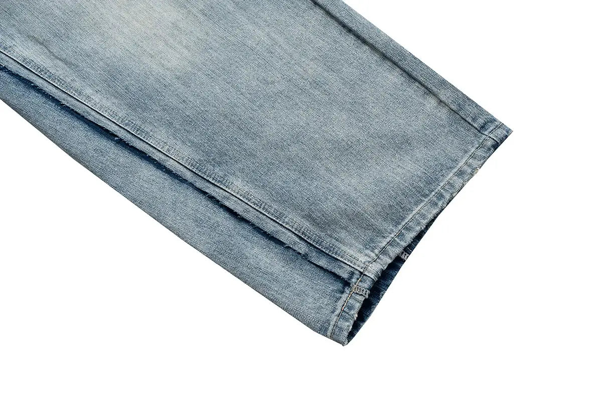 Denim jeans leg in light blue with folded cuff, straight loose-fit.