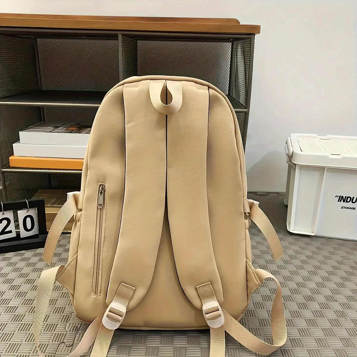 Beige large-capacity sports travel backpack with padded straps and a vertical side zipper pocket