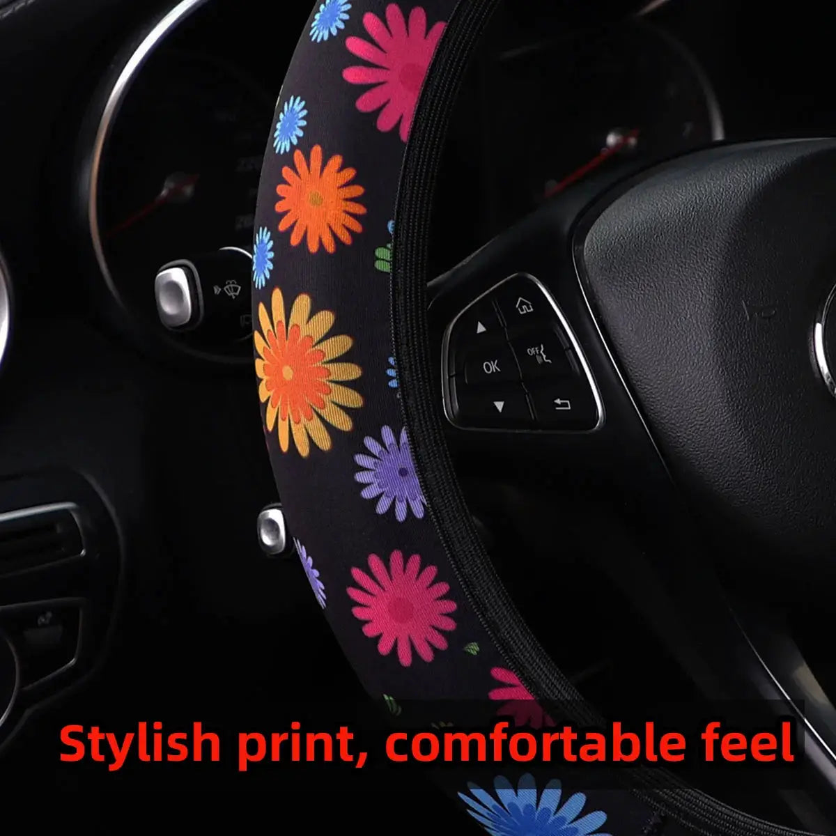Steering wheel cover, 38cm, bold multicolor floral print on black fabric.