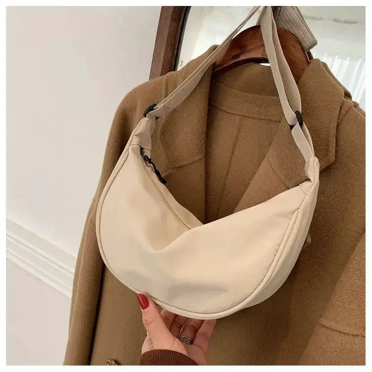 Nylon dumpling bag, cream crescent-shaped small shoulder bag with an adjustable strap