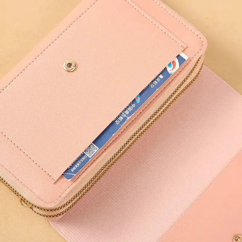 Women's mid-size pink wallet bag with convertible shoulder clutch, coin pocket and gold-tone zipper