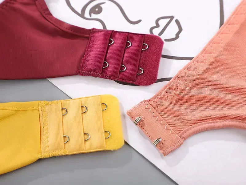 Women seamless no-wire push-up bra set of 3 colors in burgundy, yellow, and peach with back hook closures.