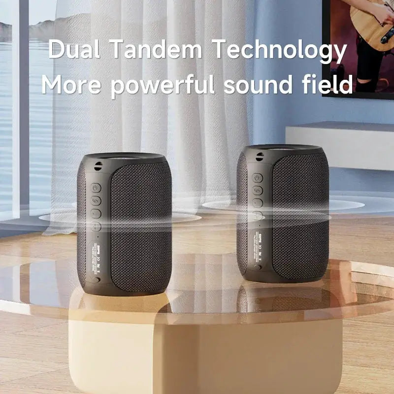 ZEALOT-S32PRO Bluetooth speaker pair in black on a glass table.