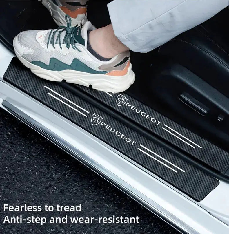 Car door sill protector with carbon-fiber finish and Peugeot logo branding