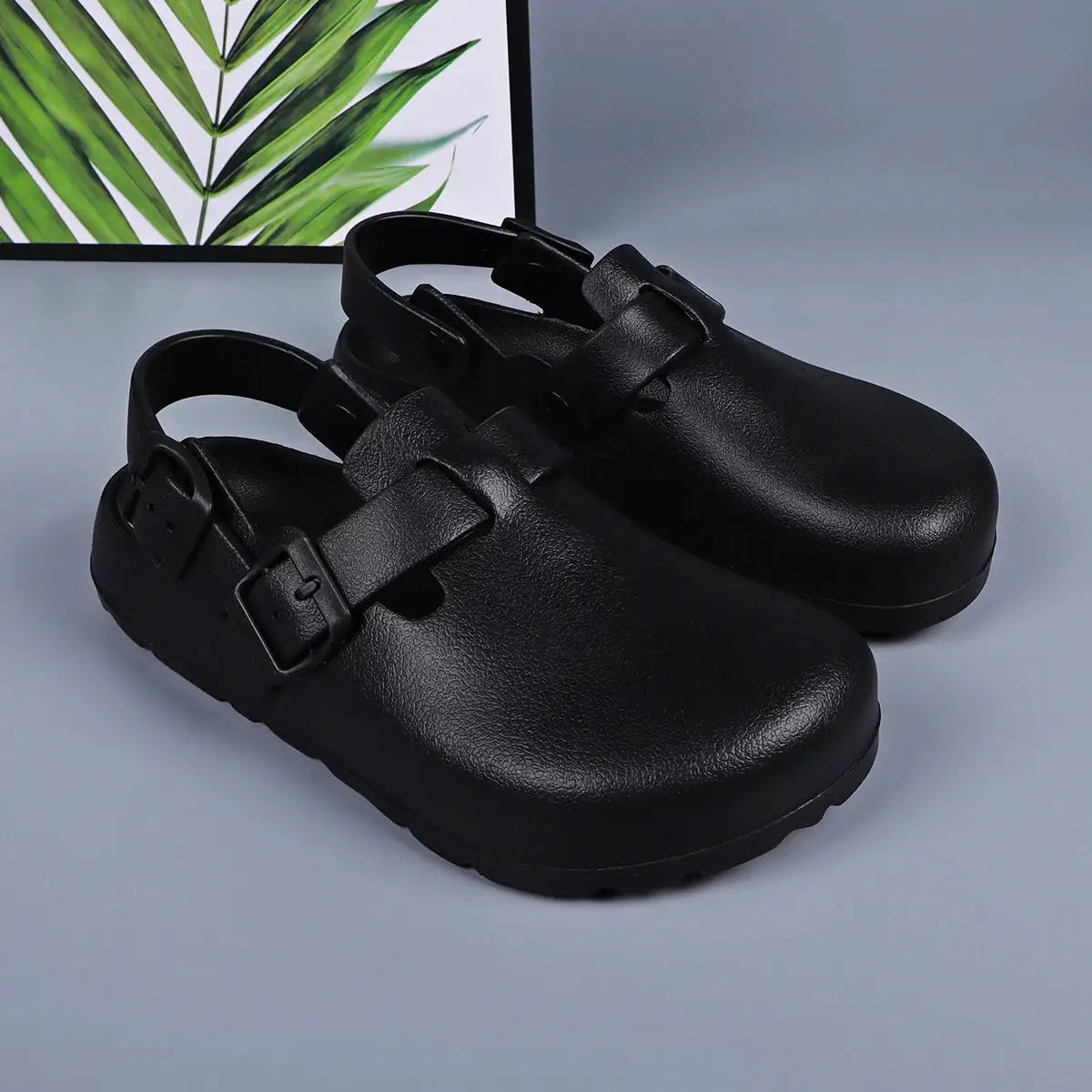 Black mule clogs with adjustable buckle straps; pair with chunky platform sole