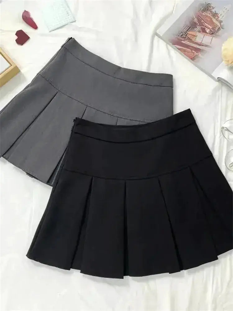 Two high-waist pleated mini skirts in gray and black, school-uniform style.