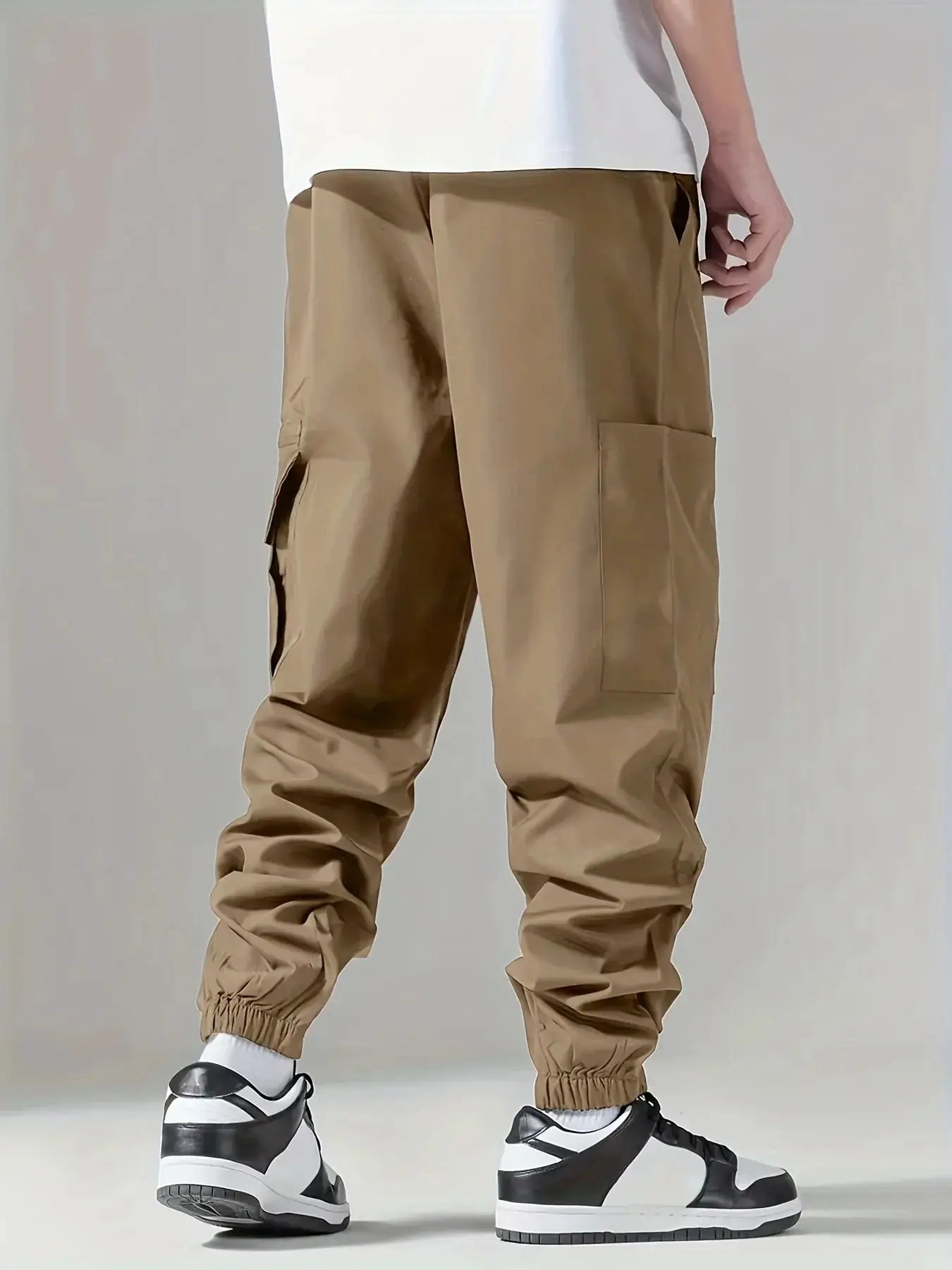 Men's cargo pants in tan with large side pockets and elastic cuffs by Simples Market