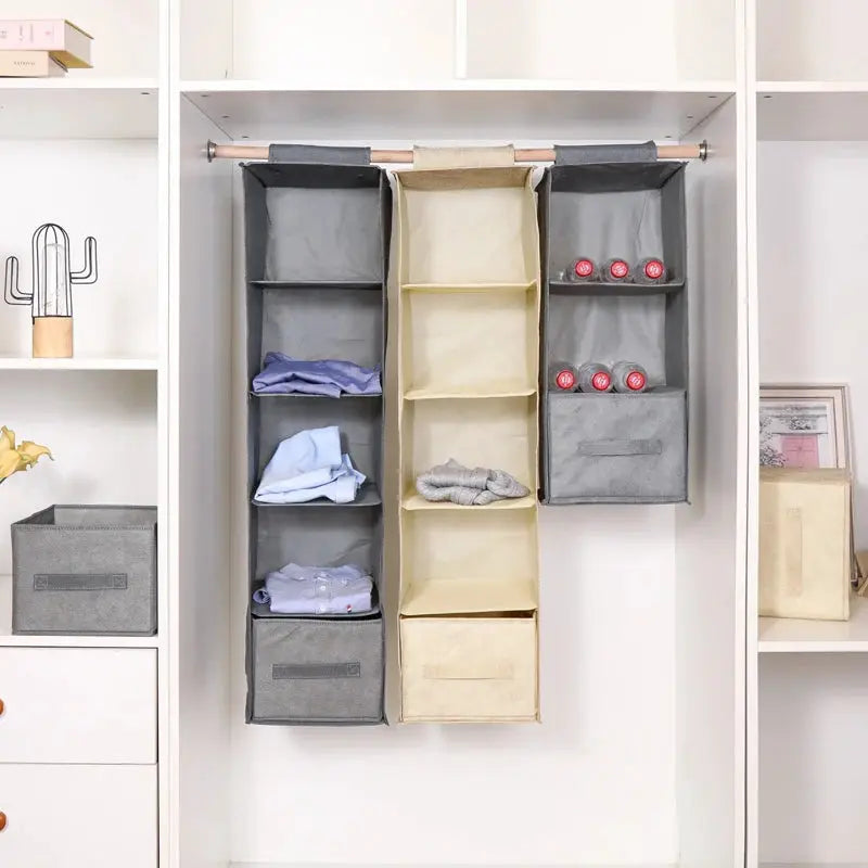 Three cotton-linen hanging wardrobe storage organizers in gray and beige with collapsible shelves