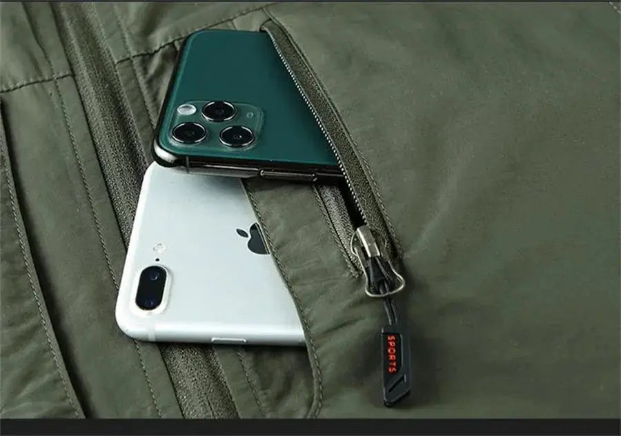 Sleeveless jacket vest in olive green with zip pockets holding two smartphones.