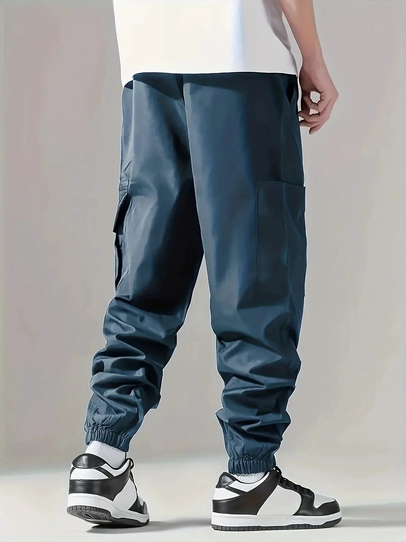Men's cargo pants in blue, lightweight outdoor trousers with multiple pockets and elastic cuffs