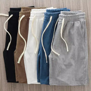 Men's waffle-texture shorts with drawstrings; six colorways in mid-waist casual knee-length style.