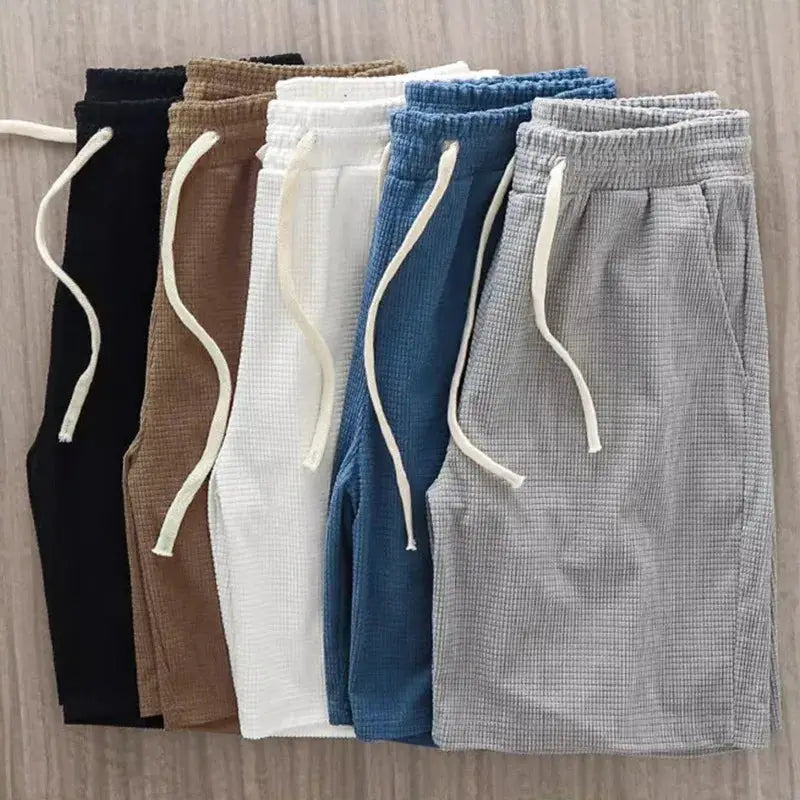 Men's waffle-texture shorts with drawstrings; six colorways in mid-waist casual knee-length style.